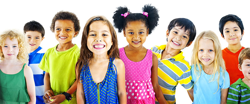 The image shows a diverse group of children with varying skin tones and hair colors, standing in a row against a white background, smiling at the camera.